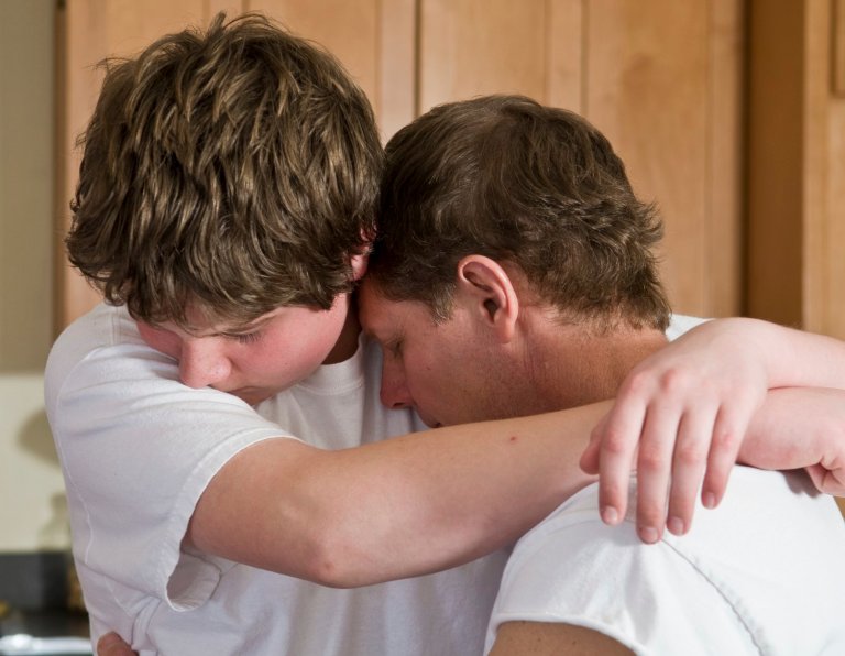 emotional hug, father and son father and teenage son embrace, as if reconciling after conflict