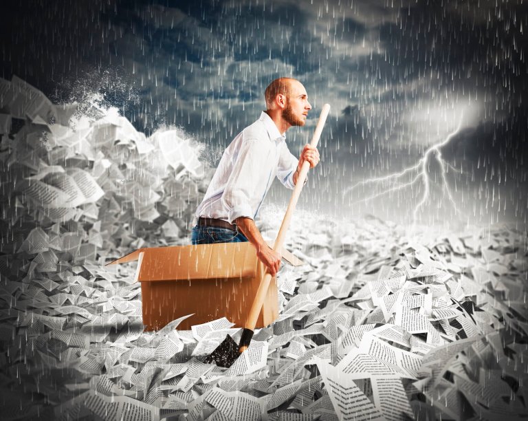 Navigate the bureaucracy Man paddling in a sea of sheets