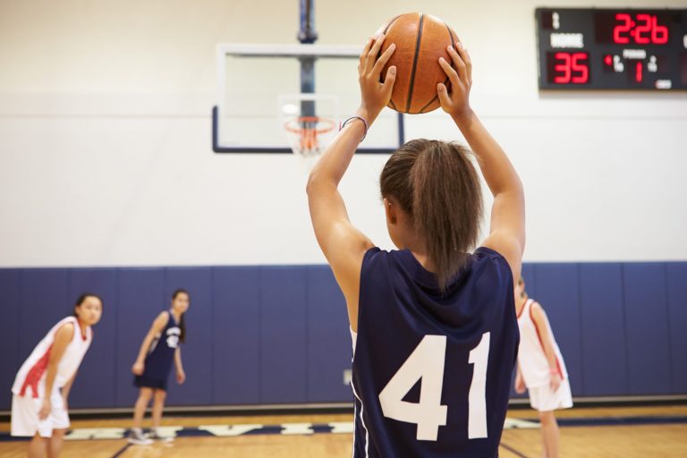 Female High School Basketball Player Shooting Basket Female High School Basketball Player Shooting Basket