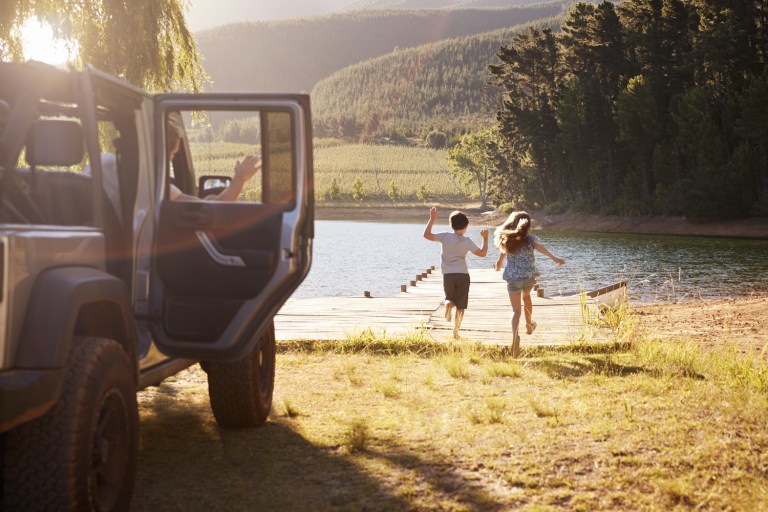 family reaching destination by lake after road trip family reaching destination by lake after road trip
