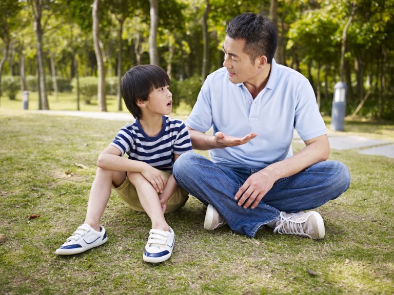 asian father and son having a conversation asian father and son having a conversation